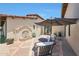 A serene outdoor patio with a water feature, elegant seating, and manicured landscaping at 10152 E Phantom Way, Scottsdale, AZ 85255