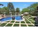 Enjoy a tranquil retreat with this beautifully landscaped pool and lounge area at 10152 E Phantom Way, Scottsdale, AZ 85255