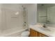 This bathroom features a shower over tub, vanity with wood cabinets, toilet, and mirror at 10370 W Sands Dr # 463, Peoria, AZ 85383