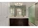 Bathroom featuring double sinks, a large mirror, and a shower with glass doors at 10370 W Sands Dr # 463, Peoria, AZ 85383