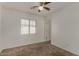 Bedroom with neutral carpet, natural light from windows, and a doorway at 10370 W Sands Dr # 463, Peoria, AZ 85383