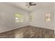 Spacious bedroom featuring wood-look floors, a ceiling fan, and three windows at 10370 W Sands Dr # 463, Peoria, AZ 85383