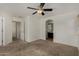 Bright bedroom featuring a ceiling fan, neutral carpeting, and an ensuite bathroom at 10370 W Sands Dr # 463, Peoria, AZ 85383