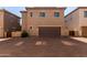 Exterior view of the home showcasing the garage and front entryway at 10370 W Sands Dr # 463, Peoria, AZ 85383