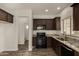 Stylish kitchen featuring dark cabinets, granite countertops, and stainless steel appliances at 10370 W Sands Dr # 463, Peoria, AZ 85383