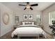 The main bedroom has a large bed, neutral decor, and two windows offering natural light and a serene atmosphere at 10370 W Sands Dr # 463, Peoria, AZ 85383