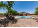 This backyard features an in-ground pool, patio, and low-maintenance desert landscaping at 10735 E Kilarea Ave, Mesa, AZ 85209