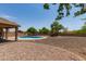 This backyard features an in-ground pool and low-maintenance desert landscaping at 10735 E Kilarea Ave, Mesa, AZ 85209