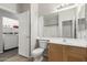 Bathroom with a vanity, toilet, and a laundry room in view at 10735 E Kilarea Ave, Mesa, AZ 85209