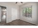 Bedroom with neutral walls, a ceiling fan, and a large window providing ample natural light at 10735 E Kilarea Ave, Mesa, AZ 85209