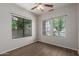 Bedroom featuring neutral walls, a ceiling fan, and large windows allowing plenty of natural light to flood in at 10735 E Kilarea Ave, Mesa, AZ 85209