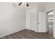 The bedroom features a closet with sliding doors, light gray walls, and wood-look floors at 10735 E Kilarea Ave, Mesa, AZ 85209