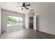 Bright bedroom featuring a modern ceiling fan, light grey walls, and a great view of the pool outside at 10735 E Kilarea Ave, Mesa, AZ 85209