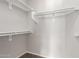 Walk in closet featuring white shelving and bars for maximum storage capacity and organization at 10735 E Kilarea Ave, Mesa, AZ 85209