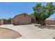 Tan single-story home featuring a two-car garage and desert landscaping in a suburban neighborhood at 10735 E Kilarea Ave, Mesa, AZ 85209