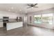 Open kitchen boasts white cabinets, a kitchen island, and stainless steel appliances with a pool view at 10735 E Kilarea Ave, Mesa, AZ 85209