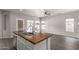 Island sink with modern faucet in a spacious kitchen and connected living space with lots of natural light at 10735 E Kilarea Ave, Mesa, AZ 85209