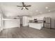 Bright kitchen featuring white cabinets, an island with sink, and stainless steel appliances at 10735 E Kilarea Ave, Mesa, AZ 85209