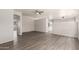 Spacious living room with light gray walls, wood-look floors, ceiling fan, and multiple archways at 10735 E Kilarea Ave, Mesa, AZ 85209