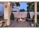 Backyard fire pit area with built in seating, landscaping, and decorative wall art at 1085 E Oakland Ct, Gilbert, AZ 85295