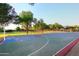 Community basketball court and green space surrounded by mature trees, offering outdoor recreation at 1085 E Oakland Ct, Gilbert, AZ 85295