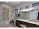 Bathroom with tile shower, granite countertops, double sinks and vanity at 1085 E Oakland Ct, Gilbert, AZ 85295