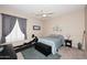 Serene bedroom with a calming blue palette, complemented by a ceiling fan and window shutters at 1085 E Oakland Ct, Gilbert, AZ 85295