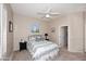 Neutral toned bedroom with a queen bed, ceiling fan, and carpet floors at 1085 E Oakland Ct, Gilbert, AZ 85295