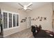Cozy bedroom with a ceiling fan, large shuttered window, and neutral carpet at 1085 E Oakland Ct, Gilbert, AZ 85295