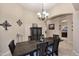 Open dining room with a rustic wooden table set under a chandelier, showcasing interior archways at 1085 E Oakland Ct, Gilbert, AZ 85295