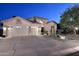 Attractive home exterior featuring a three-car garage and desert landscaping at 1085 E Oakland Ct, Gilbert, AZ 85295