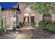 Stunning front entrance featuring well-lit walkway, desert landscape, and decorative stone accents at 1085 E Oakland Ct, Gilbert, AZ 85295