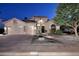 Charming home showcasing a three-car garage, desert landscaping, and inviting front entrance at twilight at 1085 E Oakland Ct, Gilbert, AZ 85295