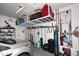 Well-organized garage space with overhead storage racks and shelving for tools and accessories at 1085 E Oakland Ct, Gilbert, AZ 85295