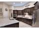 Modern kitchen boasts granite countertops, stainless steel appliances, and sleek dark wood cabinets at 1085 E Oakland Ct, Gilbert, AZ 85295