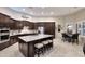 Open-concept kitchen with an island, breakfast bar, stainless appliances, and abundant storage at 1085 E Oakland Ct, Gilbert, AZ 85295