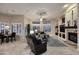 Spacious living room with a fireplace, backyard access, and tile flooring at 1085 E Oakland Ct, Gilbert, AZ 85295