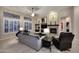 Inviting living room features a stone fireplace, built-in shelving, and plenty of natural light at 1085 E Oakland Ct, Gilbert, AZ 85295