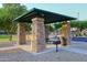 Community picnic area with a covered pavilion, stone columns, and barbecue grill at 1085 E Oakland Ct, Gilbert, AZ 85295