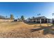 Spacious backyard with a pool, a covered patio, and a large grass area at 12043 N 46Th Ave, Glendale, AZ 85304