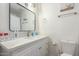 Bright bathroom featuring a vanity with marble countertop, a toilet, and a shower at 12043 N 46Th Ave, Glendale, AZ 85304