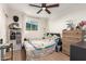 Bedroom featuring wood floors, a ceiling fan, a window, and a wooden dresser at 12043 N 46Th Ave, Glendale, AZ 85304