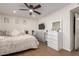 Inviting bedroom with ceiling fan, dresser, and vanity with great natural light at 12043 N 46Th Ave, Glendale, AZ 85304