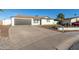 Single-story home with a well-maintained front yard, desert landscaping, and a gray garage door at 12043 N 46Th Ave, Glendale, AZ 85304