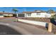 Charming home with a well-maintained front yard, desert landscaping, and a gray garage door at 12043 N 46Th Ave, Glendale, AZ 85304