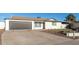 Single-story home with a well-maintained front yard, desert landscaping, and gray garage door at 12043 N 46Th Ave, Glendale, AZ 85304