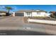 Charming home with a well-maintained front yard, desert landscaping, and a gray garage door at 12043 N 46Th Ave, Glendale, AZ 85304