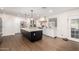 Spacious white kitchen with stainless steel appliances, large island, and wood-look tile flooring at 12043 N 46Th Ave, Glendale, AZ 85304