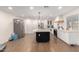 Open kitchen featuring white cabinets, stainless steel appliances, and large dark island with light countertop at 12043 N 46Th Ave, Glendale, AZ 85304