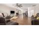 Bright living room with wood-look tile floors, ceiling fan, and plenty of natural light at 12043 N 46Th Ave, Glendale, AZ 85304
